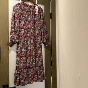 Very pretty long sleeve floral dress and goes past the knees. Perfect condition!